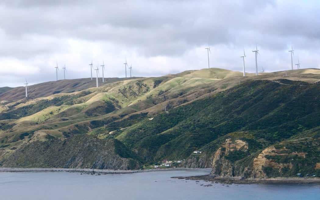 Wind turbines above the Wellington coastline at Makara Beach.