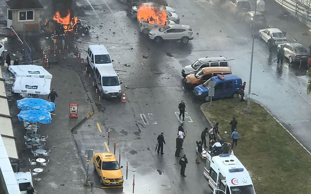 Cars burn in the street at the site of an explosion in front of the courthouse in Izmir in Turkey.