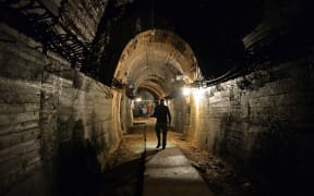 Men walk in underground galleries, part of Nazi Germany "Riese" construction project under the Ksiaz castle in the area where the "Nazi gold train" is supposedly hidden underground
