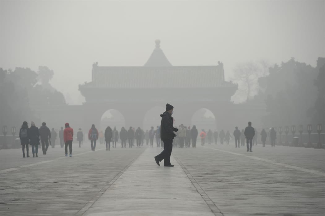 A man walks through smog at a the Temple of Heaven park in Beijing last month.