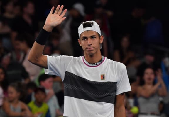 Australia's Alexei Popyrin reacts after the retirement of Austria's Dominic Thiem during their men's singles match at  the Australian Open tennis tournament in Melbourne on January 17, 2019.