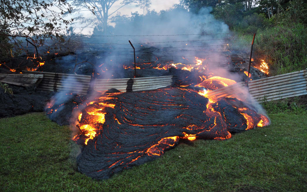 Red-hot lava from a slow-erupting volcano has reached a home on Hawaii's Big Island and is threatening an entire town.
