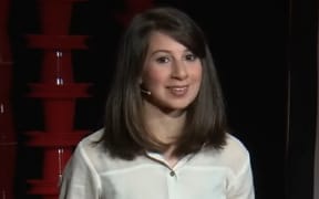 Katie Bouman giving a TED talk.