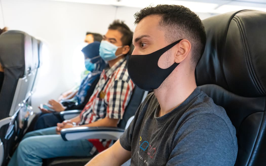 Masked passengers on a flight
