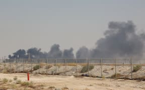 Smoke billows from an Aramco oil facility in Abqaiq about 60km southwest of Dhahran in Saudi Arabia's eastern province on 14 September.