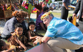 Australian prime minister Scott Morrison speaks to kids at a climate change display in Tuvalu ahead of the Pacific Islands Forum leaders summit on Funafuti. August 2019