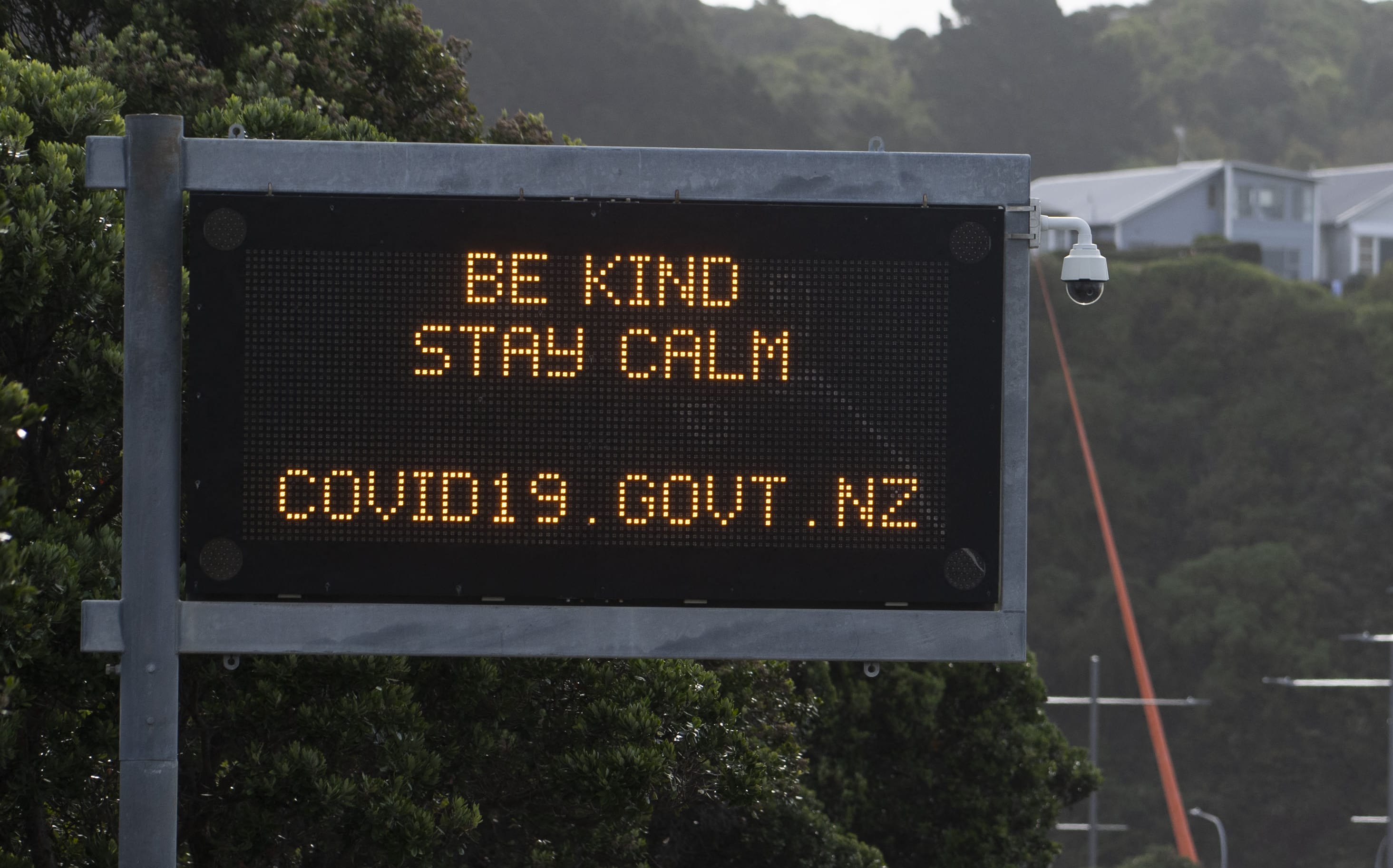 A motorway sign reads "Be kind and stay calm" along a street devoid of cars in response to the COVID-19 coronavirus outbreak in Wellington on April 20, 2020.