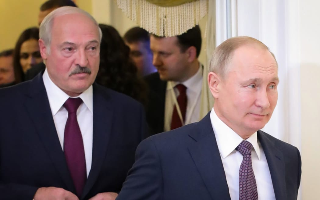 (FILES) This file photo taken on December 20, 2019 shows Russian President Vladimir Putin (R) followed by Belarusian President Alexander Lukashenko (L), entering a meeting hall during the Supreme Eurasian Economic Council, in Saint Petersburg. -