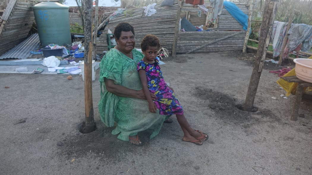 A widow and her granddaughter, in front of what used to be their home, Shepherd Islands.