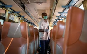 A worker of an intercity bus company disinfects the bus as a preventive measure against the spread of the COVID-19 coronavirus in Kampala, Uganda.
