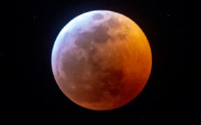 Earth's shadow almost totally obscures the view of the so-called Super Blood Wolf Moon during a total lunar eclipse.