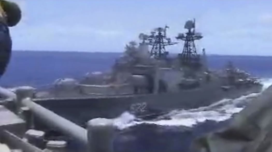 In this image from video provided by the U.S. Navy, a Russian destroyer, left, sails very close to the USS Chancellorsville, right, while operating in the Philippine Sea, Friday, June 7, 2019.