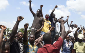 Protesters chant and sing solidarity songs as they barricade barricade the Lagos-Ibadan expressway to protest against police brutality and the killing of protesters by the military, at Magboro, Ogun State, on October 21, 2020.