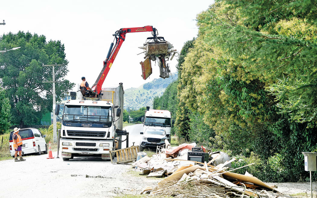 A truck removes belongings left by the roadside in Te Karaka this week.  The small town of 500 people, about half an hour from Gisborne, was particularly hard hit by Cyclone Gabrielle.