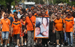French RCN (racing club de Narbonne) supporters hold a picture of All Black's Jerry Collins and his partner.