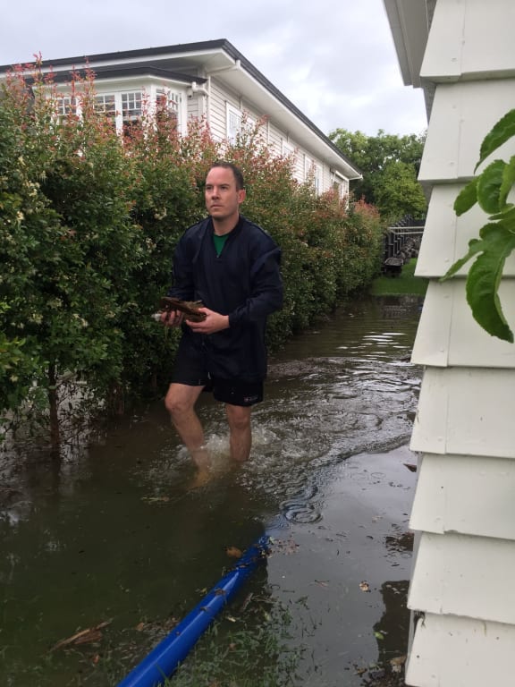 Brennan Fell outside his flooded Mt Albert house.