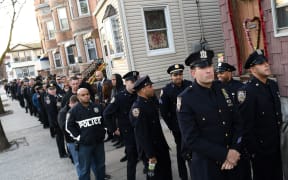 Police officers from the New York City area line up for the wake for Rafael Ramos.
