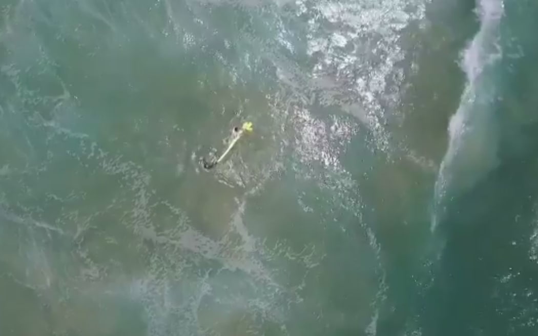 The drone dropped an inflatable rescue device which the two teenagers used to get to shore.