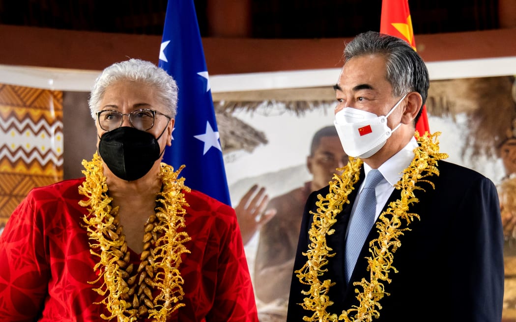 This picture released by the Samoa Observer on May 28, 2022 shows Chinese Foreign Minister Wang Yi (R) and Samoa Prime Minister Fiame Naomi Mataafa attending agreements signing ceremony between the two countries in Apia. (Photo by Vaitogi Asuisui MATAFEO / SAMOA OBSERVER / AFP) / --- EDITORS NOTE --- RESTRICTED TO EDITORIAL USE