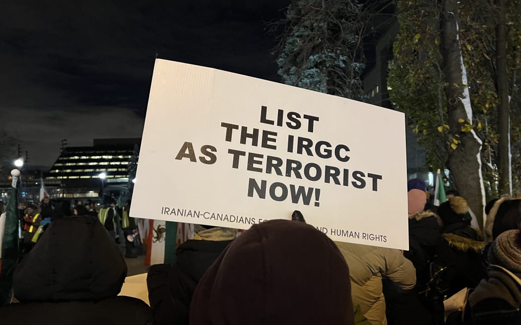 A man at a protest in Toronto, Canada against the Iranian Islamic regime on 16 November 2022 holds a sign urging the Canadian government to list the Islamic Revolutionary Guard Corps as a terrorist organisation. Canada is one of the countries which has now done that.