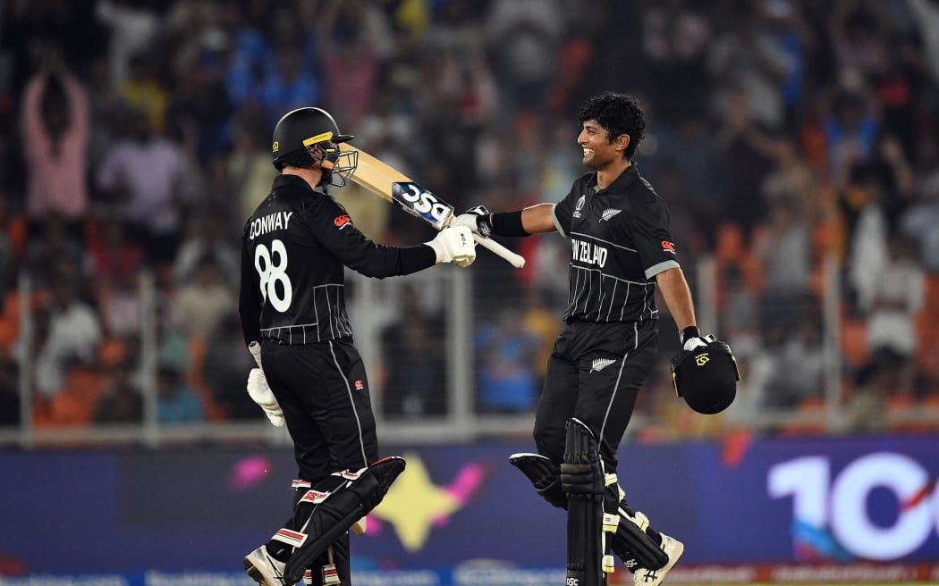 New Zealand batsman Rachin Ravindra (R) celebrates his century with his team-mate Devon Conway.