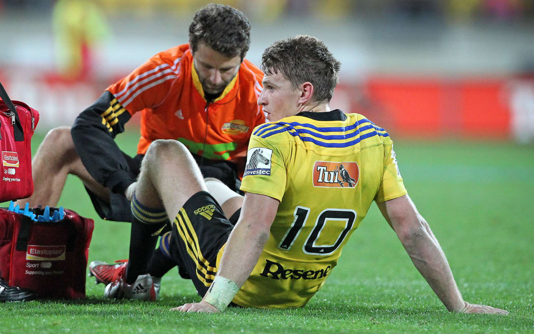 Hurricanes first five Beauden Barrett gets treatment for his injured knee.