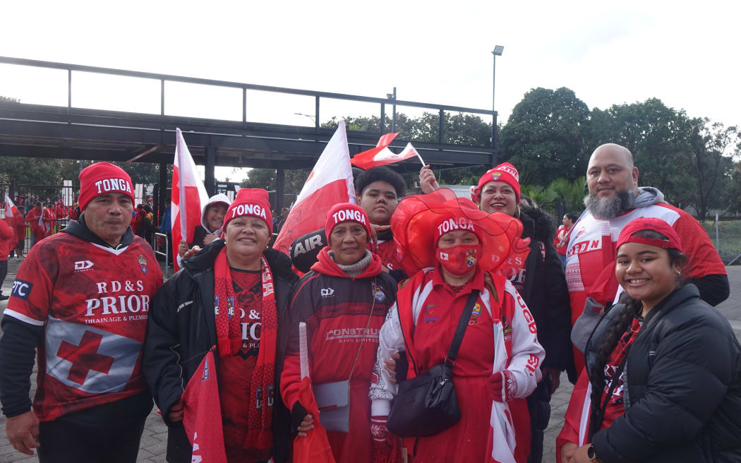 Fans wave the Tonga flag.