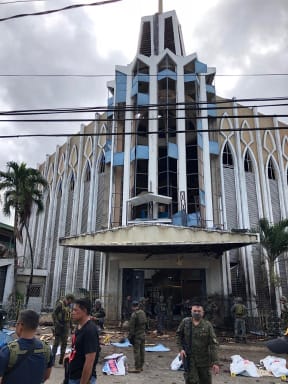 Armed Forces of the Philippines photo shows soldiers in front of a Catholic Church where two bombs exploded in Jolo, Sulu province on the southern island of Mindanao.
