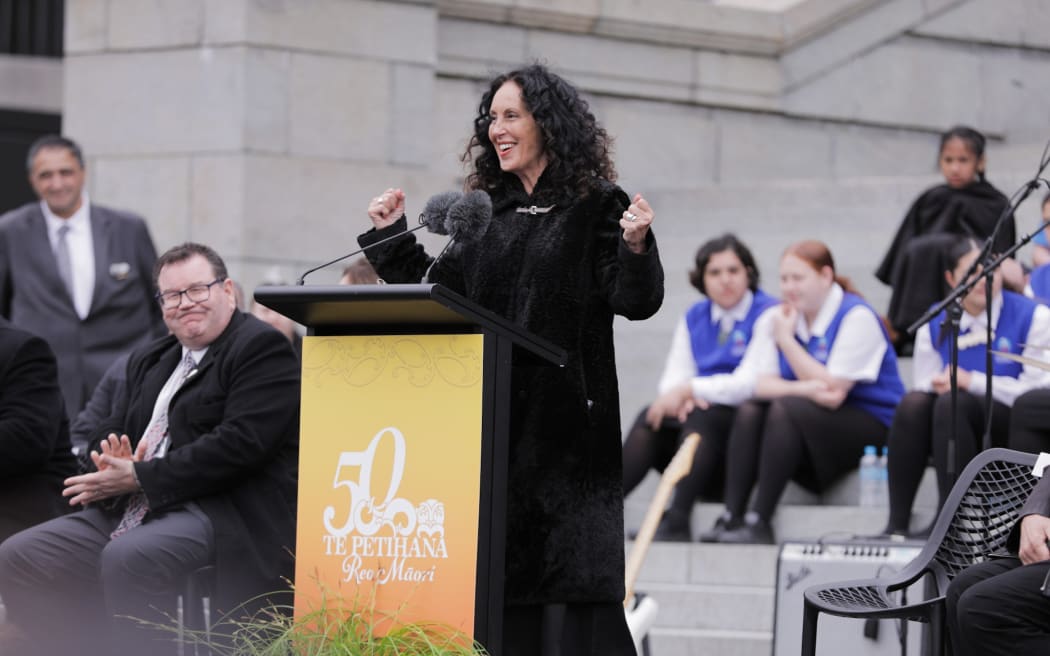 Moana Maniapoto speaks to crowds who have gathered outside Parliament in Wellington on 14 September, to marks 50 years since the Māori Language Petition was presented to Parliament.