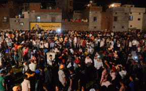 Indian relatives and revellers gather around the bodies of the victims of a train accident.
