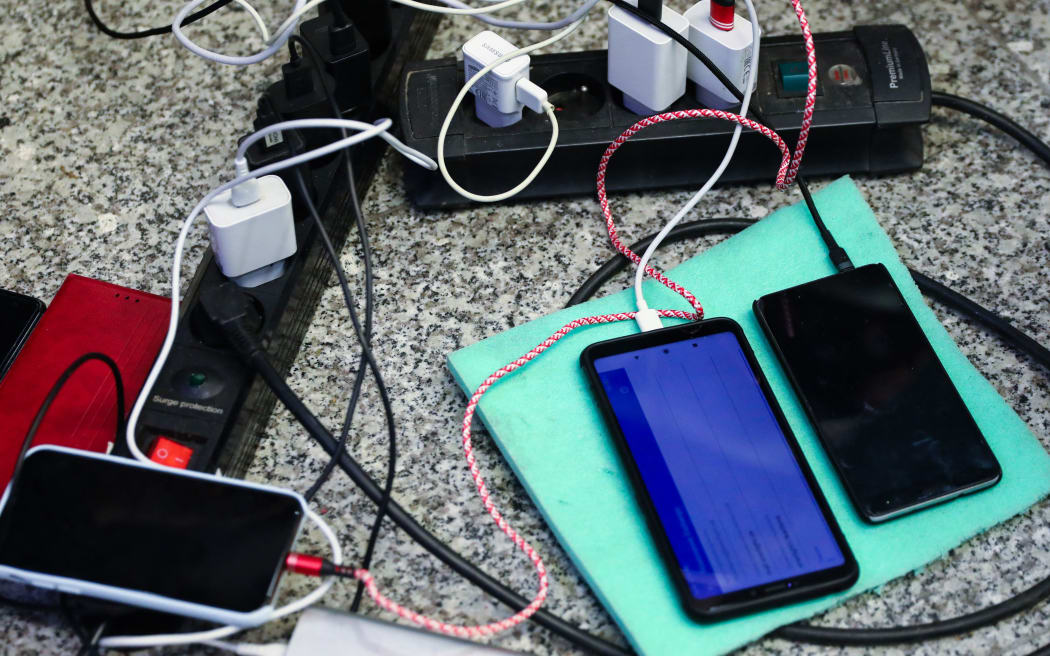 Mobile phones of refugees who arrived from Ukraine are charging at the main railway station in Krakow, Poland on March 8, 2022. Russian invasion on Ukraine can cause a mass exodus of refugees to Poland.   (Photo by Beata Zawrzel/NurPhoto) (Photo by Beata Zawrzel / NurPhoto / NurPhoto via AFP)