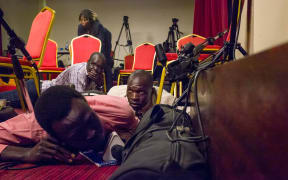 Journalists lie on the floor of a press room in the presidential palace after shots on the building shortly before the start of a planned press conference with the president of South Sudan, Salva Kiir Mayardit, and his deputy, Riek Machar.