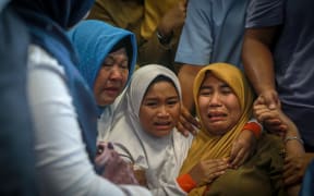 Family members of the crashed Indonesian Lion Air JT-610 react at Pangkal Pinang airport.