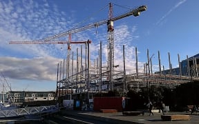 Construction with cranes against a blue sky