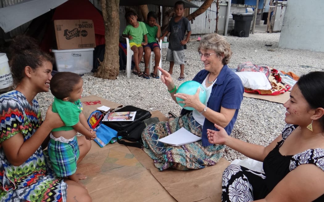 Early Hearing Detection and Intervention program staff Chinilla Peter (right) and Nancy Rushmer teach sign language to a mother and young child who is hearing impaired during a home visit in Majuro in this file photo from 2015.