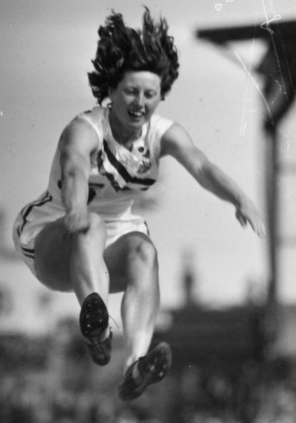 Yvette Williams in an attempt to break her own long jump world record in Dunedin during a visit of Queen Elizabeth II and Philip, Duke of Edinburgh