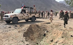Yemeni security forces rush to the scene of a missile attack on a military camp west of Yemen's government-held second city Aden, on 1 August, 2019.