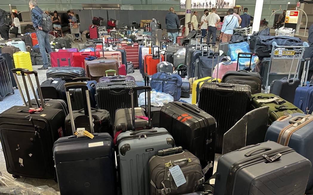 Suitcases are seen uncollected at Heathrow's Terminal Three baggage reclaim, west of London on July 8, 2022. - British Airways on Wednesday axed another 10,300 short-haul flights up to the end of October, with the aviation sector battling staff shortages and booming demand as the pandemic recedes.  (Photo by Paul ELLIS / AFP)