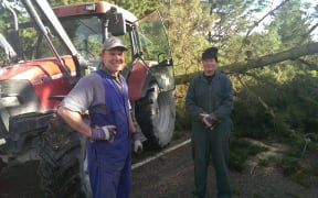Cran Dalgetty and Murray Howard clear fallen trees in West Melton.