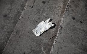 A discarded glove outside a supermarket in South Auckland