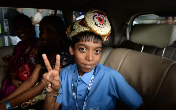 Indian chess prodigy Rameshbabu Praggnanandhaa, poses for a photo on his arrival at the airport in Chennai after becoming the second youngest chess grandmaster in the world in 2018.