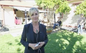 Erin Brockovich talks to John Campbell in the backyard of an earthquake damaged home in Richmond, Christchurch