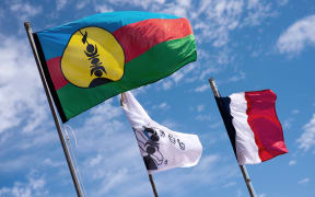Kanak and French flags on Ouvea island.