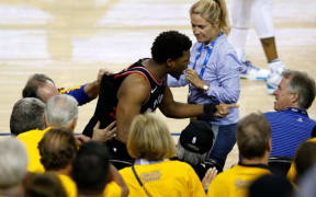 Kyle Lowry #7 of the Toronto Raptors yells at investor Mark Stevens in the second half against the Golden State Warriors during Game Three of the 2019 NBA Finals.