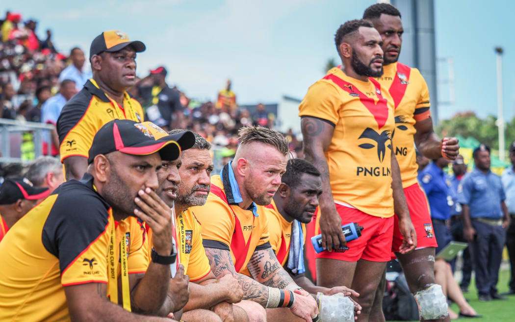 PNG Kumuls coach Michael Marum (L), assistant coach Marcus Bai (2L) and other watch on from the sideline.