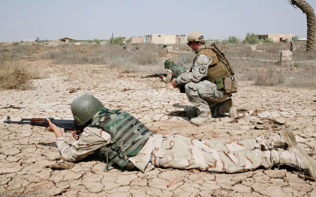A New Zealand Defence Force trainer instructs ISF soldiers in correct weapons firing positions. Iraq - 2015