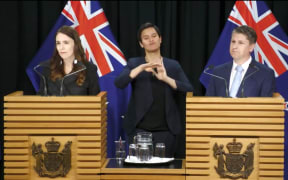 Prime Minister Jacinda Ardern and Workplace Relations and Safety Minister Michael Wood speak after a Cabinet meeting.