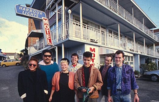 The Holidaymakers check out the Harbour Lights Motel, Parnell, 1988. From left: Mara Finau, Pati Umaga, Barbara Griffin, Richard Caigou, Peter Marshall, Stephen Jessup, and Andrew Clouston.