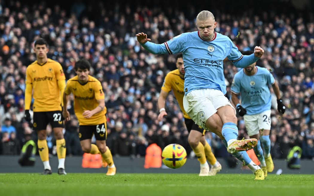 Manchester City's Norwegian striker Erling Haaland shoots a penalty kick and scores his team second goal during the English Premier League football match between Manchester City and Wolverhampton Wanderers  at the Etihad Stadium in Manchester, north west England, on January 22, 2023. (Photo by Paul ELLIS / AFP) / RESTRICTED TO EDITORIAL USE. No use with unauthorized audio, video, data, fixture lists, club/league logos or 'live' services. Online in-match use limited to 120 images. An additional 40 images may be used in extra time. No video emulation. Social media in-match use limited to 120 images. An additional 40 images may be used in extra time. No use in betting publications, games or single club/league/player publications. /