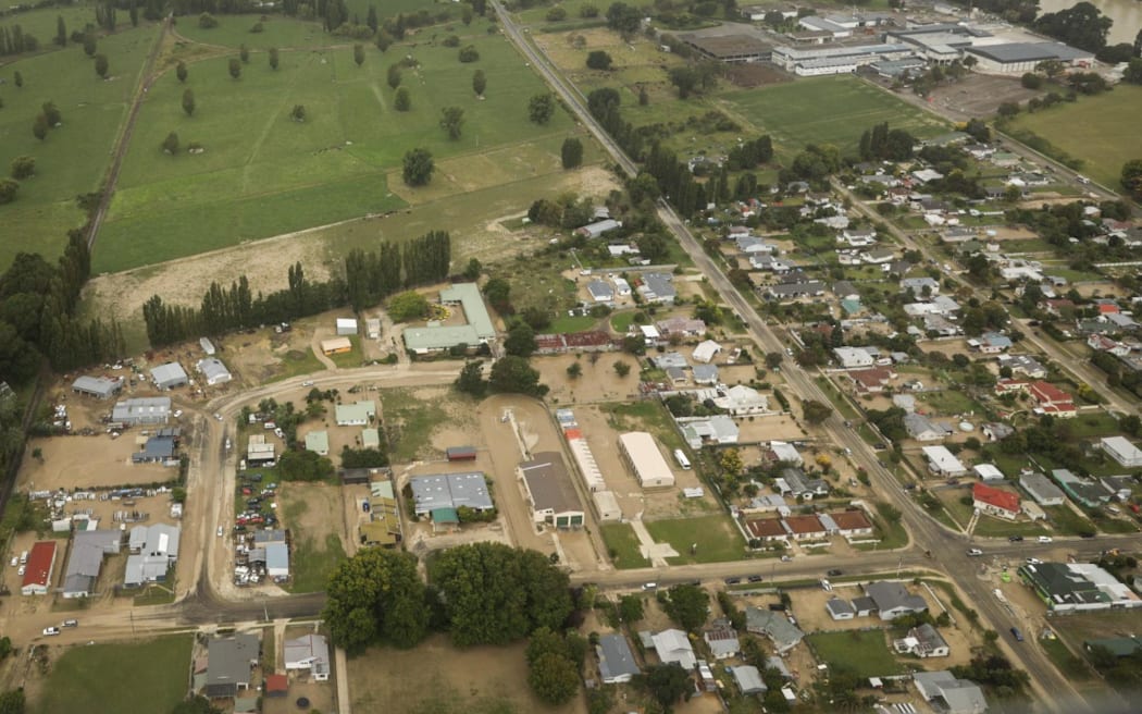 Wairoa from the air shows flood waters and mud throughout the town